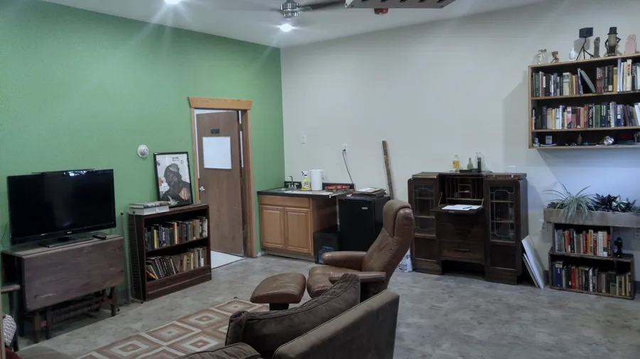 Leather chairs, bookshelves and a television in the waiting room